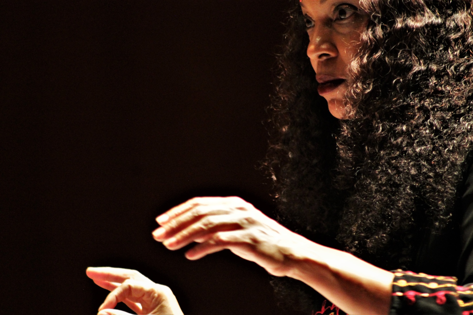 Coco Elysses conducting on stage